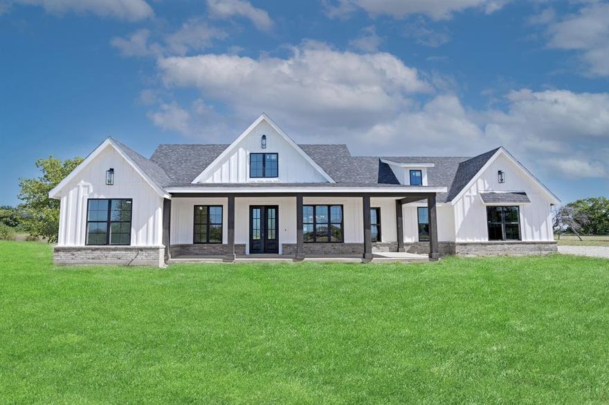 Modern, brand new home on 2 acres of land! Double Iron black doors at front entrance with Double-Pane 100% Tempered Glass
leads to an open floor plan with large windows and doors combined with 17' vaulted ceilings gives a very light feel! Plumbing, appliances, air conditioning systems, roof, and more are all new, offering peace of mind with warranties on new construction electrical and air conditioning! The kitchen features custom cabinets with Quartz counter tops and matching back splash. An island in the kitchen leads into a living room that features an electric fireplace with remote control. You can find Soho Gloss White Herringbone tile in baths.  Enter the mud room from the garage and leave your jacket on the built in cabinets before taking your groceries to the walk-in pantry.  Waterproof and Durable Mohawk Vinyl wood plank flooring throughout. Catch a breeze under the ceiling fans that are throughout, including the back patio. Relax in the free standing tub or in the custom frame-less shower glass in the master bath.  Store all of the extras in the full attic. Gravel drive leads you through the mature grass and shrubs to a 2 car garage with custom doors by Custom door by Tolbert with storage and parking.  45 minutes to Fort Worth or an hour drive to Dallas. Enjoy the sunsets on the front or back porches!
** The grass in the front yard does not go to the front porch as shown in the pictures