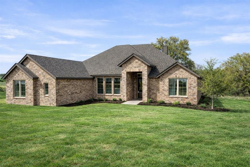 Experience elevated country living on just over an acre where space, style, and freedom come together beautifully. This thoughtfully designed 4-bedroom home with a dedicated study, 3 full bathrooms, and a spacious 3-car garage offers just under 2,400 square feet of highly functional, open-concept living perfect for both everyday comfort and effortless entertaining. At the heart of the home, the upgraded kitchen showcases Level 5 quartz countertops, an abundance of premium finishes, and sleek matte black fixtures throughout, creating a modern yet timeless aesthetic. The kitchen flows seamlessly into the expansive family room, where a striking painted brick fireplace extends to the ceiling, accented by a custom-stained mantle. Custom built-in cabinetry on either side, paired with floating wood shelves, adds both sophistication and functionality. The private primary suite offers a true retreat, featuring a spa-like bathroom complete with a freestanding soaking tub, perfect for relaxation. Designed for modern living, the home also includes a mud bench with a built-in desk and charging station for added convenience and organization. Step outside to enjoy the extended covered patio ideal for entertaining or unwinding while taking in the peaceful surroundings. Architectural details continue with cedar posts framing the inviting front porch and matching cedar shutters enhancing the third bedroom and garage windows, creating timeless curb appeal. Enjoy the added benefits of a no-HOA community and a low tax rate, offering greater flexibility and long-term value. Blending upscale finishes with the tranquility and privacy of country living, this exceptional property is truly a place to call home.
