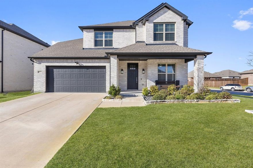 Discover a perfect balance of style, comfort, and convenience in this beautifully designed home. With a bright, open-concept floor plan, this residence is designed for effortless living and entertaining. Large windows fill the home with natural light, enhancing the fresh, modern interior. The spacious living area features a striking stone fireplace, creating a cozy focal point for gatherings, while the adjacent dining space offers a seamless flow for hosting family and friends. The well-appointed kitchen boasts sleek countertops, stainless steel appliances, custom cabinetry, and an oversized island with ample seating—ideal for casual meals or meal prep. Retreat to the serene primary suite, where you'll find a spa-like ensuite bath complete with dual vanities, a soaking tub, a separate walk-in shower, and an oversized closet with built-in shelving. Additional bedrooms provide plenty of space for family, guests, or a dedicated home office. Step outside to a covered patio, a perfect space for morning coffee or weekend BBQs. The fenced backyard offers privacy and ample space for play, gardening, or future outdoor enhancements. Additional highlights include a dedicated laundry room with storage, a two-car garage, and thoughtful design details throughout. Situated in a desirable community with easy access to top-rated schools, shopping, dining, and major highways, this home offers both comfort and convenience in an excellent location.