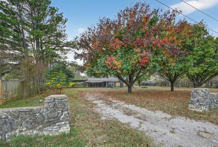 Large treed lot with this three bedroom, two bathroom home in Eastwood Village on the west side of Granbury. Floorplan and lot offer plentiful opportunity for new owner. Features include a covered front porch overlooking the tree shaded front lawn, carport and additional parking opportunities for RV and boat on the lot, large covered patio with owners suite patio door access and screened in area with hot tub to enjoy, dog run and kennel set area set up. Living area with wood burning stove and great natural lighting. Island kitchen is complete with abundant cabinetry, access to patio and island. Primary bedroom is sizable with ensuite bathroom with dual vanities, walk in shower with bench seating and walk in closet. Backyard also includes a 10x13 workshop shed with electric. View today!