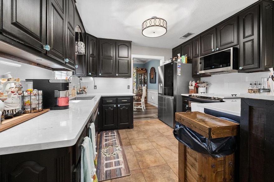 Situated on an almost half-acre corner lot, this well-maintained home offers space, privacy, and a long list of thoughtful updates. Featuring 3 bedrooms and 2.5 bathrooms with a desirable split-bedroom layout, this home is designed for both comfort and functionality. The oversized living room provides plenty of space for gathering and entertaining, while the updated kitchen shines with new countertops, backsplash, and modern laminate flooring installed in 2023. Major system upgrades add peace of mind, including a new HVAC system and ductwork (2021), a Class 4 impact-resistant roof (2024), and a new water heater (2024). Additional recent improvements include a new dishwasher (2025), microwave (2024), remodeled primary shower (2025), all toilets replaced (2025), and brand-new carpet in the bedrooms (2026). Outdoor living is just as impressive with an extended covered patio—perfect for relaxing or entertaining—along with partial new fencing, added gutter guards, storm doors, and solar screens for enhanced efficiency and comfort. This move-in-ready home combines modern updates with generous lot size—don’t miss your opportunity to own this exceptional property!