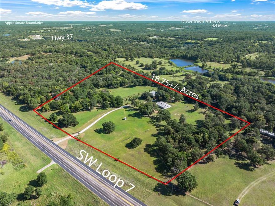 Imagine yourself waking up each morning surrounded by the peaceful serenity of your own horse property. From a rocking chair on the front porch, you can soak in the calm of the countryside. Step inside, and the view from your living room windows becomes a natural work of art, showcasing rolling pastures, mature trees, and a pond stocked with bass and white belly catfish. This 18.75-acre property offers roughly 844 linear feet of Loop 7 frontage, making it highly accessible and versatile. The improvements include a 3536 square foot barndominium with 1456 square feet of finished living space and 2080 square feet of garage space complete with two roll up doors, ideal for ample storage or easily finished out for additional living quarters. For equestrian needs, a 4000 square foot horse barn is designed with five 20x20 birthing stalls, a tack room, and an office with dog kennels, providing space for horses, dogs, and other animals. The land is fenced and cross fenced, offering flexibility for livestock, chickens, and gardens. The property also boasts a flourishing orchard with pear, peach, plum, nectarines, Chinese chestnut, pecan, blackberry, elderberry, beauty berry, and both domestic and wild grape vines, along with wild sumac berries — ideal for fresh fruit or canning. Adding to the beauty of the landscape are black walnut trees and a pair of live oaks, while an abundance of hickory trees provide shade and character throughout the property.
This property blends function with beauty, offering endless possibilities for country living, from homesteading and hobby farming to enjoying evenings by the wood line in pure East Texas tranquility. All of this comes with the added benefit of a country lifestyle with the convenience of downtown Athens eateries, shops, and grocery stores just minutes away. With a new survey already in place, this property is ready for its next chapter.