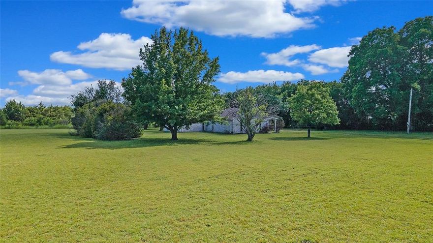 Discover the freedom and flexibility of true country living on this beautiful 4.41-acre property in an unincorporated area with no known restrictions. Ideal for horses, goats, chickens, and more, the land is fully fenced (excluding the driveway) with a cleared front pasture for grazing or gardening and a wooded back section that provides exceptional privacy and a peaceful natural backdrop.

The light-filled home is designed for comfort and entertaining, featuring a spacious living area with a wood-burning fireplace, wood beam accents, and custom built-ins. The updated kitchen offers a gas range, generous counter space, and seamless flow into a formal dining room. A versatile sunroom or second living area allows for a home office, gym, or additional living space. The oversized primary suite is a private retreat with its own gas fireplace, dual walk-in closets, and a spacious ensuite bath. Major updates include windows replaced in 2015 and water heaters replaced in 2020.

Located in Anna—one of the fastest-growing cities in the U.S.—this property offers the rare balance of privacy and convenience. Just 6 minutes from Downtown Anna, currently undergoing a $10 million dining and entertainment expansion planned for 2026, 11 minutes from Anna Crossing Park with 28 acres of recreation, and 11 minutes from Rosamond Corners with Kroger and Starbucks coming in 2026. With ample room for outdoor living or future expansion, this is a unique opportunity to enjoy space, growth, and city amenities all in one exceptional setting.