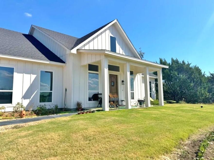 Stunning 3-year-old modern farmhouse offering secluded country living with exceptional views. This gorgeous custom home features an open-concept floor plan with high ceilings, sealed concrete floors, and an abundance of natural light throughout. The spacious living area features a real stone fireplace and windmill-style ceiling fan, opening to a well-appointed kitchen with a large island, black granite countertops, farm-style cabinets, stainless-steel appliances, walk-in pantry, under-counter accent lighting, and luxury lighting package. The home offers 3 split bedrooms, each with walk-in closets, and 2.5 baths featuring white granite countertops and recessed sinks. Relax in luxury in your primary suite with dual sinks, garden tub and separate shower. Oversized utility room with sink makes laundry day a breeze. Great covered porch and large covered patio extend your living - entertaining space outdoors. Additional upgrades include bronze hardware, solid core doors, Low-E windows, and 2x6 exterior walls providing enhanced insulation for improved energy efficiency. Enjoy the natural landscape with large oak trees, a gas stub-out on the back porch for grilling, and a water well for low utility costs. Too much to list, MUST SEE! Owner must approve all pets. Tenant must maintain septic system.