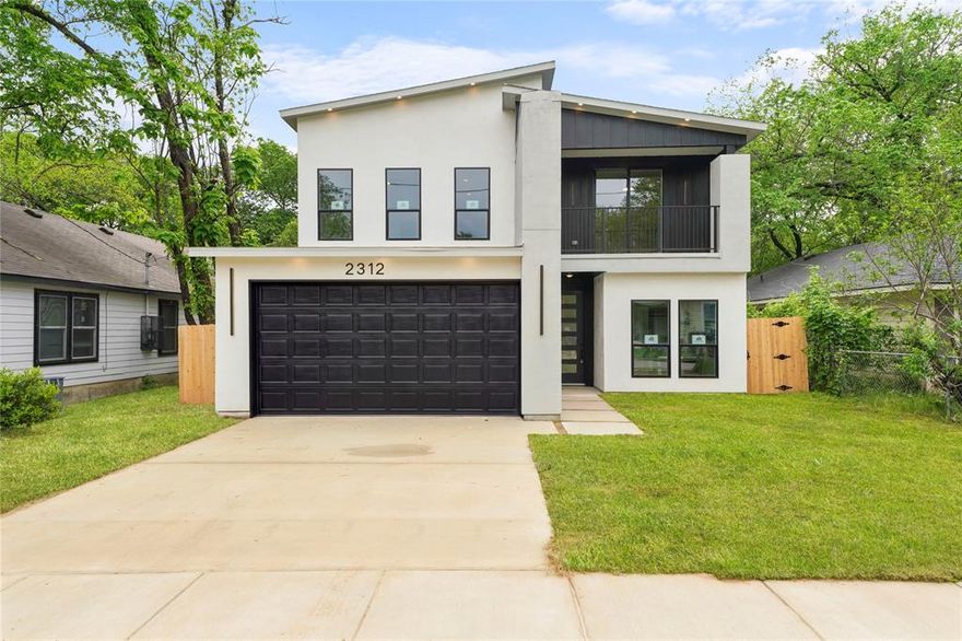 Modern design, natural light, and the kind of layout buyers actually want. 2312 Stoneman St brings bold modern design, thoughtful functionality, and elevated finishes together in one striking new construction opportunity just minutes from the heart of Dallas. Offering 2,106 square feet, 4 bedrooms, 3 full bathrooms, this home delivers style without sacrificing comfort. The moment you step inside, soaring ceilings and expansive windows fill the living space with natural light, creating an open and airy atmosphere that feels both impressive and inviting. The sleek fireplace wall adds warmth and character, while the open-concept design flows effortlessly into a standout kitchen featuring custom two-tone cabinetry, quartz-style surfaces, statement lighting, abundant storage, built in appliances with refrigerator included, and a large island ready for casual mornings or weekend gatherings. The primary suite offers a calming retreat with generous space, backyard views, and a spa-inspired bathroom completed with a dramatic walk-in shower and refined designer finishes with LED lighting. Upstairs, the media room gives you flexible space for movie nights, gaming, a home office, or second living area, while the second-floor patio creates the perfect place to enjoy your morning coffee or unwind in the evening. Spacious secondary bedrooms, modern fixtures, clean architectural lines, and quality craftsmanship continue throughout the home. Outside, the fenced backyard offers room to play, entertain, garden, or simply enjoy your own outdoor space. Located near Downtown Dallas, Fair Park, Deep Ellum, major highways, dining, entertainment, and everyday conveniences, this home combines fresh construction with city accessibility and modern lifestyle appeal. Schedule your showing and experience it for yourself.