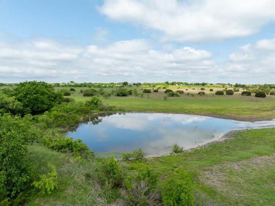 This 230-acre ranch property is now available, located on paved roads outside Cranfills Gap in the scenic Lanham Area of Hamilton County, Texas. Sycamore Creek traverses the land, offering seasonal water flow and creating natural potential for a future large lake, thanks to existing watersheds and topography. The property also features a large tank, ideal for livestock or recreational purposes.

The ranch features a charming brick home of approximately 2,100 square feet, offering three bedrooms and two full bathrooms. The house is currently leased, presenting a great investment opportunity for buyers seeking income-producing potential.

The land is ag-exempt and dotted with native grasses, scattered mesquites, and cedar trees. It offers a balance of open pasture and light cover—ideal for grazing, wildlife, or future improvements.

This prime location is just 10 miles from Hamilton, where residents enjoy quality healthcare, dining, boutique shopping, and fitness options. The property is located in an area where students may attend Hamilton, Cranfills Gap (8 miles away), or Jonesboro ISD.

Whether you’re looking for a homestead, a hunting weekend property, a cattle ranch, or a long-term investment, this property offers value and potential in Hamilton County!

Seller willing to sell the land only.