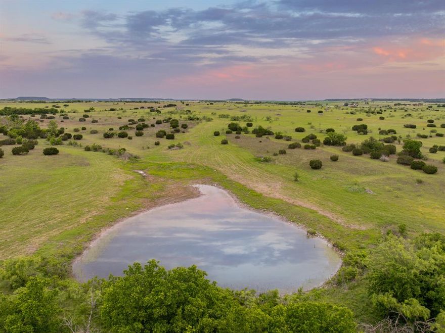 This 230-acre ranch property is now available, located on paved roads outside Cranfills Gap in the scenic Lanham Area of Hamilton County, Texas. Sycamore Creek traverses the land, offering seasonal water flow and creating natural potential for a future large lake, thanks to existing watersheds and topography. The property also features a large tank, ideal for livestock or recreational purposes.

The ranch features a charming brick home of approximately 2,100 square feet, offering three bedrooms and two full bathrooms. The house is currently leased, presenting a great investment opportunity for buyers seeking income-producing potential.

The land is ag-exempt and dotted with native grasses, scattered mesquites, and cedar trees. It offers a balance of open pasture and light cover—ideal for grazing, wildlife, or future improvements.

This prime location is just 10 miles from Hamilton, where residents enjoy quality healthcare, dining, boutique shopping, and fitness options. The property is located in an area where students may attend Hamilton, Cranfills Gap (8 miles away), or Jonesboro ISD.

Whether you’re looking for a homestead, a hunting weekend property, a cattle ranch, or a long-term investment, this property offers value and potential in Hamilton County!

Seller willing to sell the land only.
