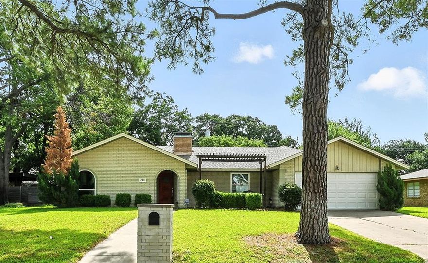 ONE-OF-A-KIND 3 BEDROOM HOME NESTLED ON A LARGE LOT WITH TONS OF MATURE TREES! Step past the pergola covered front porch & inside to this lovingly maintained home graced with an open-concept floor plan, wood flooring, plantation shutters, LED lighting, vaulted ceilings, a split bedroom layout, recently replaced AC unit & large windows that provide lots of natural light. Enjoy gatherings in the cozy family room featuring a brick fireplace & built-in entertainment center, or prepare meals in the modern kitchen showcasing upgraded countertops, stainless steel appliances & a pantry. Unwind in the secluded primary suite offering a built-in dresser, wainscoting, a dual sink granite vanity, vanity mirrors with hidden medicine cabinets, soaking tub, separate shower & a walk-in closet with built-ins & an automatic light. The oversized garage with a sink is perfect for XL vehicles. Spend time with friends & family in your huge backyard including a spacious patio, trees & plenty of room for outdoor fun. Great location in a quiet, established neighborhood close to schools & multiple city parks. Easy access to major highways & DFW Airport. Take a first-person look at this gorgeous home! Click the Virtual Tour link to see the 3D Tour!