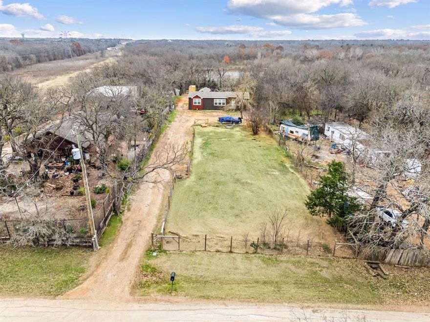 Discover the perfect opportunity to build your dream home on this beautifully improved 0.82-acre homesite in Mansfield, Texas. Conveniently located and zoned to highly rated Mansfield ISD schools, this spacious lot offers the ideal setting for custom construction, future investment, or creating the private retreat you’ve always envisioned. This property comes equipped with co-op water and septic already installed, offering significant savings on development costs and accelerating your build timeline. The land is fenced providing privacy, security, and flexibility for a variety of residential uses. With no HOA and no deed restrictions, you enjoy the freedom to bring your own builder and design a home tailored to your lifestyle. A manufactured home, storage building, and container on the property will be professionally removed prior to closing, leaving you with a clean, ready-to-build canvas. The lot offers a mix of gravel, dirt road, and features native grasses plus open space—perfect for positioning your new home to take advantage of the site dimensions. Conveniently located near major roadways, retail, dining, and Mansfield’s growing amenities, this property combines rural space with suburban accessibility. Opportunities like this—improved land with utilities, fencing, and full flexibility—rarely hit the market. Bring your plans and start envisioning what’s possible on this exceptional Mansfield homesite.