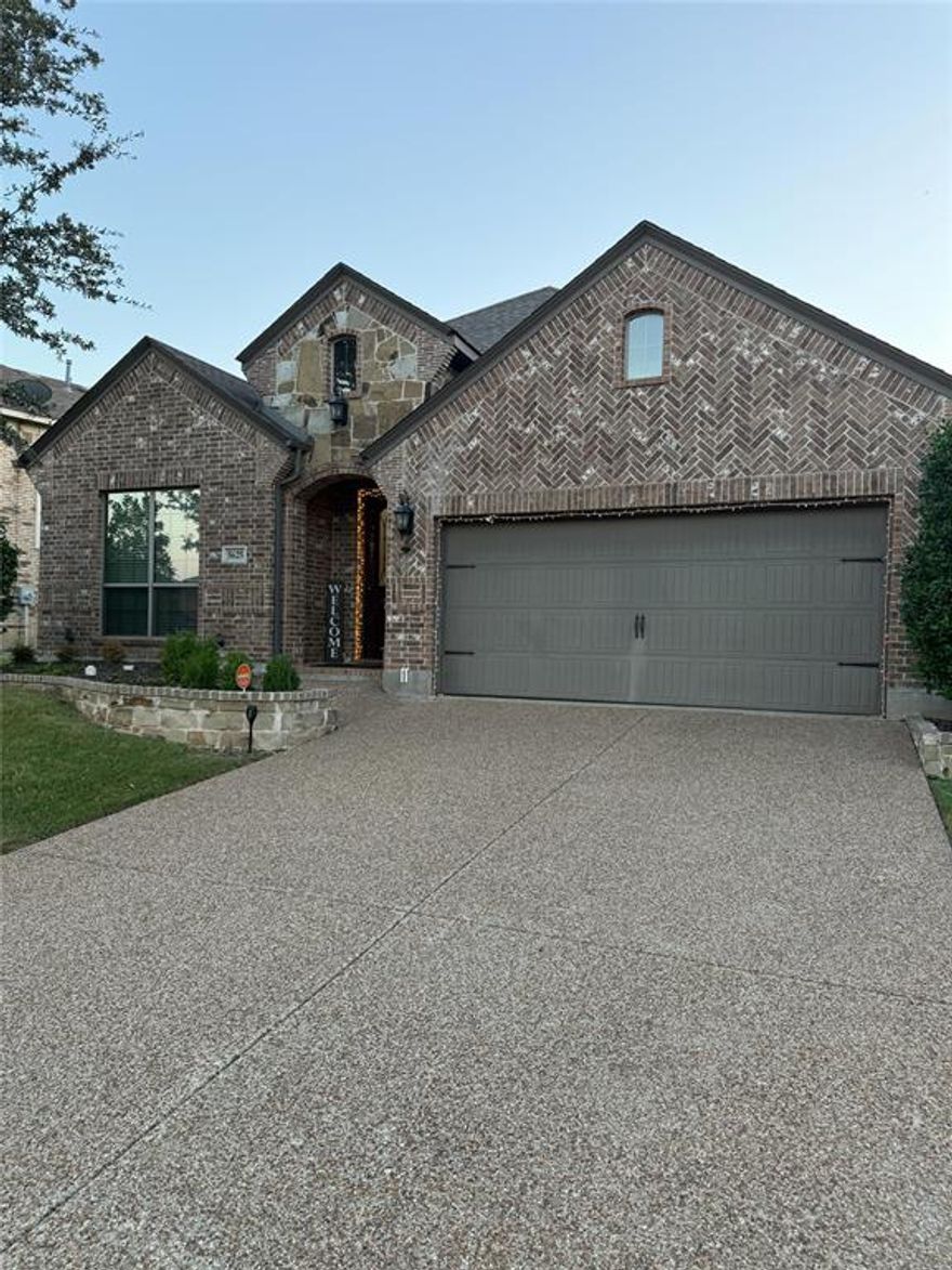 his charming single story Ranch style Traditional home is located in the Robinson Ridge Phase II subdivision in McKinney. It is a four bedroom, two full bathroom residence with approximately 2168 square feet of living space, built in 2011.

The interior features an open floorplan centered around a chef's kitchen, which boasts an oversized island, granite counters, a pantry, and built in cabinets. Appliances include a gas cooktop, built in microwave, and dishwasher. The kitchen opens to a spacious living room often highlighted by a coffered ceiling and a fireplace with gas logs. Flooring throughout the home is a mix of tile and wood.

The Primary Bedroom offers a serene retreat with a convenient window seat and an ensuite bathroom that includes dual sinks, a garden tub, a separate shower, and a large walk in closet. The three secondary bedrooms are well sized and flexible. The laundry room features a custom barn door and built in storage. Other interior features include decorative lighting and high speed internet availability.

The exterior of the home features Brick and Rock Stone construction, a wood fence, and an attached two car garage. Residents in the community enjoy amenities such as a Community Pool, playground, and sidewalks. This property is zoned for the highly regarded Prosper ISD.
