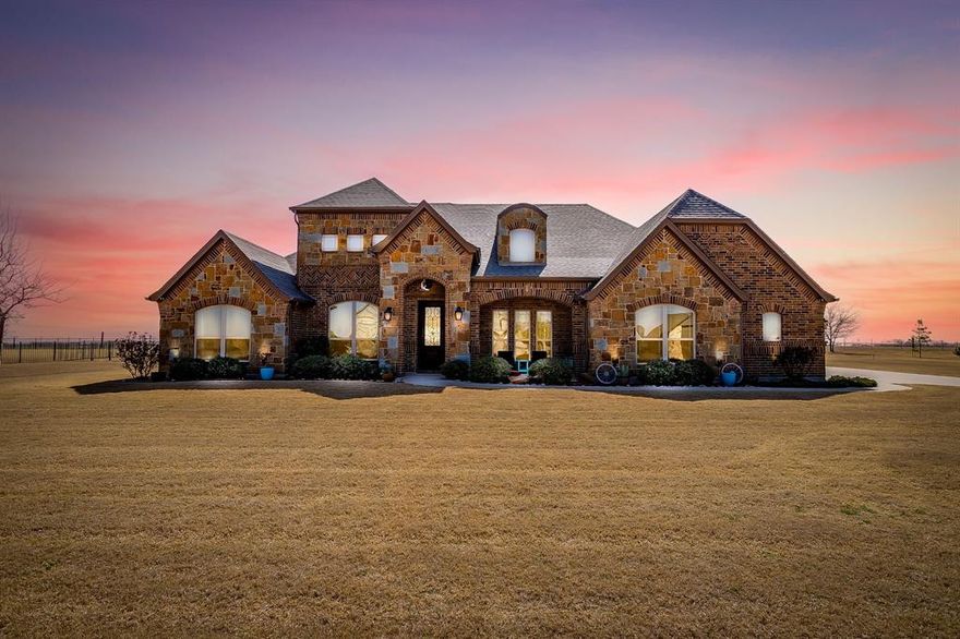 Breathtakingly beautiful home situated on a tranquil acre overlooking the artistry of Texas sky and pure country. The curb appeal alone will have you eagerly awaiting more. From the elevation peaks giving the illusion of a second story to the detached garage workshop, this home truly is a dream come true. A 5-car garage, 4 spacious bdrms' with one or two primary options, and 3 bathrooms, what more could one want? How about a chefs' delight for a kitchen! Create culinary cuisines on your oversized gas cooktop, bake in your double KitchenAid ovens, prep on your vast granite island and stock up with storage galore! Host dinner parties in the formal dining area, entertain with friends and family in the open concept floorplan, hold a private meeting in your new office, relax by the fireplace, soak your worries away in your jetted garden tub or watch the northern Texas sky on your massive back patio. Offering walk-in closets, separate vanities, separate shower and room for sitting, the primary suite provides the prefect retreat. Rich cabinetry throughout, elegant wood flooring, trayed ceilings and embellished lighting are just a few enticing details. Every corner of this home alludes quality in craftmanship and in function. New roof and gutters Feb, 2026.  All of this in the private gated community of Stone Valley. Come and see what all the fuss is about because words alone cannot capture the full essence off this magnificent property.