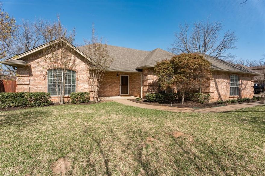 Welcome to easy living in sought-after Pecan Plantation—where comfort, convenience, & community come together beautifully. This well-maintained single-story brick home offers a versatile layout with 3 bedrooms, 2 bathrooms, a 2-car garage, plus a golf cart garage & dedicated workshop, perfect for hobbies or extra storage. Step inside to find updated vinyl plank flooring throughout the main living areas, complemented by neutral interior paint, retextured walls & ceilings, & the removal of popcorn ceilings for a clean, modern feel. The spacious living room features a cozy fireplace & flows seamlessly into a bright breakfast area & beautifully remodeled kitchen. Here you’ll enjoy quartz countertops, stainless appliances, custom cabinetry, recessed & under-cabinet lighting, marble backsplash, & a walk-in pantry designed for both style & function. Love to entertain? A formal dining room is ready for gatherings, while the expansive enclosed sunroom with tile flooring offers flexible space for a second living area, game room, or relaxing retreat. The primary suite is a true haven with dual vanities, jetted tub, separate shower, & two walk-in closets. Secondary bedrooms also feature walk-in closets, providing plenty of space for everyone. Over the years there have been major system updates providing peace of mind, including a newer roof (2024), upgraded HVAC system with air scrubber, water heater, electrical fixtures, & plumbing fixtures. Exterior improvements include gutters with leaf guards, irrigation system, landscaping updates, garage doors with opener, & fencing. Washer, dryer, refrigerator, & garage freezer all convey—making this truly move-in ready. Enjoy the unmatched lifestyle of Pecan Plantation with 24-7 gated security, golf, pools, tennis, pickleball, dining, & more—all within the community. This isn’t just a home—it’s a lifestyle.