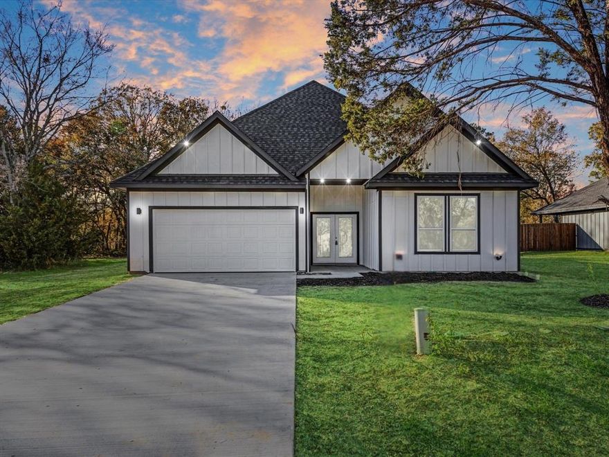 Wow! Discover this stunning new construction home featuring a modern farmhouse design and an open-concept floor plan with split bedrooms for added privacy. Cool, contemporary tones are beautifully balanced with warm accents, creating an inviting and comfortable atmosphere. The spacious kitchen offers generous counter space, abundant cabinetry, and flows seamlessly into the main living areas perfect for everyday cozy living. Large windows flood the home with natural light, enhancing the bright, airy feel throughout.