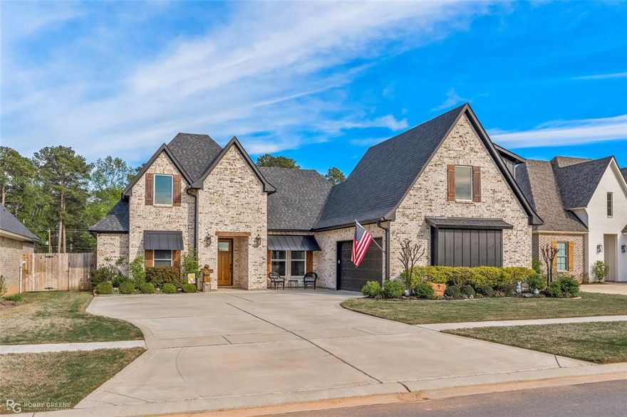 BETTER THAN NEW and thoughtfully designed, this stunning custom built home offers high end finishes and exceptional functionality throughout!  From the moment you arrive, you'll notice the attention to detail, including the commercial grade exterior lighting, full gutters, an oversized driveway and a 2 car garage.  Inside, the home features luxury vinyl plank flooring throughout the main living areas, with carpet only in the upstairs bedroom.  The heart of the home showcases a beautiful living room with a gas log gas start fireplace and custom cedar log mantle that continue as a unique design element with both inside and patio fireplaces.  The kitchen is equally impressive with leathered marbled countertops, a touch activated faucet, pot filler, and quality finishes perfect for everyday living and entertaining.  With 3 full bathrooms, the layout is both functional and flexible.  Two bathrooms feature walk in showers, while the upstairs bath offers a tub shower combo.  The home is also equipped with two on-demand  tankless water heaters for efficiency and convenience.  No wasted space in this home - even a secret storage area perfect to secure valuables.  Step outside to enjoy the covered patio complete with a wood burning fireplace, ideal for relaxing evenings while taking in the peaceful lake view from your fully fenced backyard.  Additional upgrades include a full sprinkler system, whole home generator, and Halo water system.  Located within a gated subdivision with access to wonderful schools, this home offers both comfort and peace of mind.  As a added bonus, the seller also owns the well manicured and fully fenced vacant lot directly behind the home, which can be purchased with this property or separately (see MLS #21212722 for more details).  This would provide a rare opportunity for added space and privacy.  
Call to schedule a private showing today!