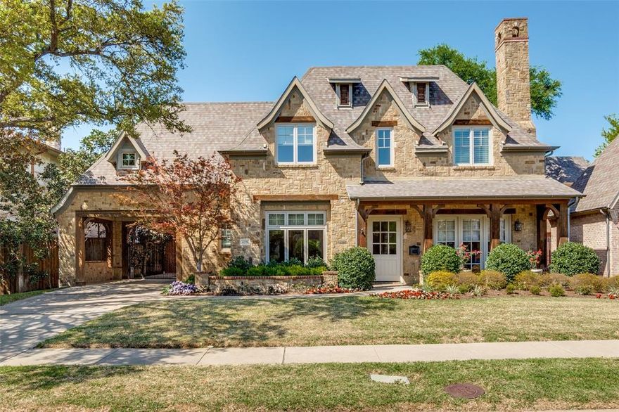 This Preston Hollow home has great drive up appeal with stone detail, a covered porch, an electric gate, and a Porte-cochère. As you enter, dramatic ceilings and natural light are highlighted in the foyer. A study is detailed featuring a handsome fireplace with custom mantel, wood beams, and French doors that lead to the front porch. Through the dining room and butler’s pantry is an eat-in kitchen with a large island and breakfast area nearby that is open to the family room. Ample cabinetry, a large walk-in pantry, and stainless steel appliances are highlights in this culinary space. A bar is nearby and ideal for entertaining. The family room overlooks the covered patio with fireplace and built-in grill. The spacious primary bedroom is downstairs and offers a sitting area with access to the backyard. The primary bathroom has a separate tub, shower, dual sinks, and closets. An elevator is conveniently close by. The second floor offers a game room with a kitchenette and a patio. Nearby, is the guest apartment that has flexibility for a mother-in-law suite or a space that offers privacy for family or friends to stay. Three more bedrooms complete this level. This home has so much to offer, suitable for discerning buyers!