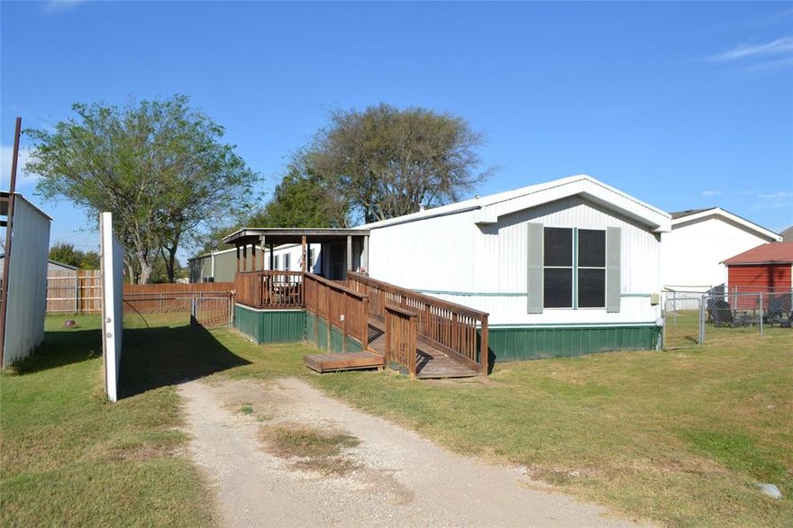 Priced to sell, 3-bedroom, 2-bathroom single-wide home featuring a split floor plan, covered porch, fenced in yard and wheelchair ramp, located in the gated community of Holiday Villages at Lake Fork. This vibrant community offers fantastic amenities, including a clubhouse, swimming pool, playgrounds, fishing piers, and boat ramps, along with plenty of engaging activities. The property includes a fenced yard and central heating and air conditioning, making it a comfortable choice for a weekend getaway, retirement retreat, or short-term rental opportunity. Possible financing with 21st Mortgage Corporation or VA loan, reach out to your lender today to see if you qualify.