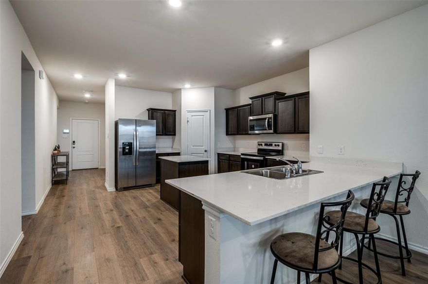 Welcome to this stunning 5-bedroom, 2-bath home built in 2023, offering a perfect blend of modern design and everyday comfort. The open-concept layout is accented by contemporary finishes and abundant natural light, creating a bright and inviting atmosphere throughout. The spacious kitchen is a true centerpiece, featuring an island, stainless steel appliances, and ample counter space ideal for entertaining family and friends. Generously sized bedrooms provide flexibility for a home office, guest space, or growing household. Step outside to enjoy a private, fenced backyard, perfect for grilling, relaxing, or outdoor gatherings. The nearby community pool offers a fun atmosphere for families to cool off, play, and unwind on warm summer days. Conveniently located in the heart of Pilot Point, close to schools, restaurants, and shopping. This home offers comfort, design, and a welcoming neighborhood lifestyle all in one place. Discounted rate options and no lender fee for future refinancing may be available for qualified buyers of this home.