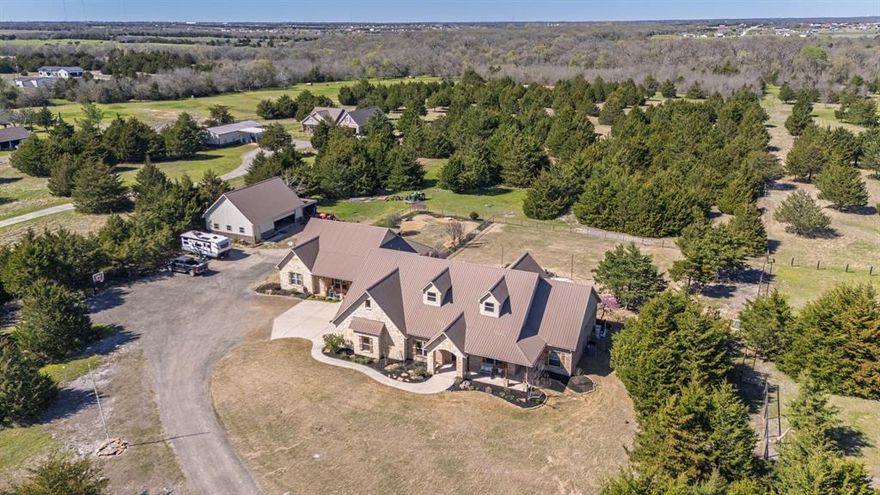 EXQUISITE & INCLUSIVE! Main and guest quarters under one roof, 10 Ag Exempt Acres, Insulated Workshop with Electric and half-bath!Caddo Mills ISD!!  Fabulous, 4185 sq ft living area includes 2583 sq ft main home and attached 1602 sq ft guest homes with separate entry! Foam Insulation, 2 tankless gas water heaters, 2 HVAC units. 3 car garage, stairs to 2 large attic storage areas! Main home includes 3 bed, 2 full baths & 1 half bath, kitchen, living room with stone gas log fireplace, dining room, Office, split bedrooms, Full outdoor kitchen, Outdoor living space, inground gunite pool (2023) with attached spa, fenced back yard. Gourmet kitchen with gas stove top, oven, built in microwave, built in refrigerator-freezer, farm sink and granite counter tops. Primary bedroom and ensuite with separate vanities, garden tub and large walk-in shower. Large custom closet includes entrance to laundry and utility room. Executive style Office with beautiful built-in shelving and storage. Open floorplan flows nicely from foyer entrance thru living room, kitchen, butler's pantry and dining room. Large windows frame your peaceful view of the Outdoor living area, outdoor full kitchen and swimming pool. Opposite the living room are 2 bedrooms and jack-n-jill bath to complete the split bedroom floorplan! The attached guest quarters with separate entry is perfect for parents, family members, or extended guests! All doors are 36 inch to accommodate wheelchair or walker. Living room with gas log fireplace, large primary bedroom with ensuite bath. Office-2nd bedroom combo includes queen size wall mounted Murphy Bed, built in cabinets and desk. Enter the separately fenced backyard thru a bright and peaceful sunroom. Outside, you will find 1200 sq ft Workshop with 450 sq ft overhang. Tons of storage upstairs in the loft area. Don't miss the opportunity to own this wonderful, hard to find, property with all the amenities you desire and need in place and ready for your enjoyment! See Documents.