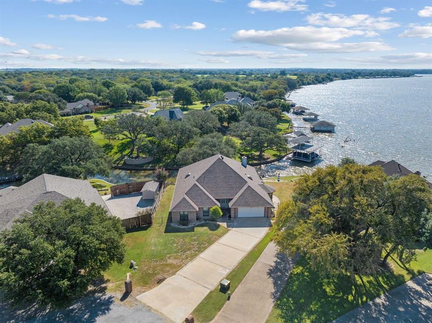 Lakefront Living in Granbury, TX! Nestled at the end of a peaceful canal with stunning main body lake views, this beautiful 4-bedroom, 2-bathroom home offers the perfect blend of relaxation and function. Enjoy life on the water with your private boat dock featuring two slips, ideal for weekends full of boating, fishing, or sunset views right from your backyard. Inside, you’ll find spacious living and family rooms, a sunroom overlooking the canal that brings approximately 400 more sqft of space, and two dining areas—perfect for entertaining or hosting family gatherings. The large kitchen is a chef’s dream, featuring granite countertops, a center island, and plenty of storage. Inside the garage you'll find epoxy floors and an elevator for making it easy to store items in the attic. Located on a quiet cul-de-sac, this home offers both privacy and easy access to all that Granbury has to offer. Whether you’re looking for a full-time residence or a weekend lake retreat, this property is truly a rare find!