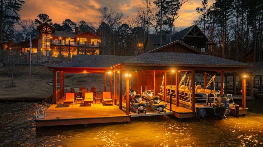 Welcome to this exquisite custom-built waterfront home, on Lake Cypress Springs, meticulously engineered with steel columns and trusses, blending modern elegance with robust construction. Spanning 4,496 sq ft of luxurious living space, complemented by an additional 1,240 sq ft of covered outdoor areas and 554 sq ft upstairs concrete deck, this residence is a testament to refined craftsmanship and thoughtful design.
At the heart of this home is the expansive open kitchen, equipped with top-of-the-line Thermador appliances, including a 48-inch refrigerator, a 6-burner gas range top, a 30-inch double oven, a dishwasher, and a microwave. Custom Hickory cabinets and elegant granite countertops create a perfect blend of functionality and style.
The spacious family room features a striking floor-to-ceiling stacked stone Isokern fireplace with gas starter providing a cozy and inviting atmosphere. 
An intimate covered wine room with an Isokern fireplace with gas starter offers a serene setting for relaxation and entertainment, perfectly designed for wine connoisseurs and enthusiasts.
Experience alfresco dining in the outdoor covered dining room, featuring a beautiful mesquite wood table that adds rustic charm and warmth to your gatherings. 
The covered outdoor kitchen is a culinary enthusiast's dream, featuring granite countertops and state-of-the-art built-in Lynx appliances, including a grill, griddle, and sink ideal for hosting outdoor parties and enjoying the waterfront views. 
This home has Corradi Auto Controlled exterior screens to add to your comfort on hot summer days.
A 1,700 sq ft covered boathouse with two stalls includes a 255 sq ft open deck, complete with a 65-inch TV housed in a protected cabinet. It also features remote-controlled tritoon and two jet ski lifts.
This custom home is a harmonious blend of elegance, comfort, and numerous modern amenities. Please see the attached list for a comprehensive overview of everything this home has to offer.