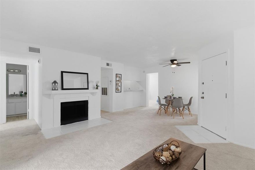 Welcome to this beautifully refreshed second-level condo in Creekbend Condos! Offering 998 square feet, this 2-bedroom, 2-bath floor plan features fresh interior paint, new carpet, and updated kitchen appliances including a new dishwasher, refrigerator, and microwave. The living area offers a comfortable layout with a woodburning fireplace and access to a private balcony, perfect for enjoying morning coffee or relaxing outdoors. The primary bedroom includes an ensuite bath, while the secondary bedroom and full bath provide flexibility for guests, a roommate, or a home office. This condo also includes an assigned covered parking space for added convenience, as well as additional uncovered, unassigned parking available. Enjoy the community pools, and clubhouse. Located close to Richland College. Move-in ready with thoughtful updates throughout!