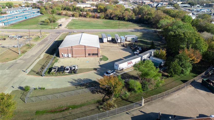 Great opportnity to own an industrial zoned building in Mesquite so close to 635 and other major freeways.  This land area is completely fenced with an electric gate entrance.  A little under 1 acre of land availalbe to add concrete parking area or building expansion space. There is approximately 1,000 SF of office and over 5000 SF of warehouse area complete with 4 bay doors, wet sink area, 220 and 3 phase power.  All overhead doors are electric and manual, easily can occomodate 18 wheeler trailers with the ceiling height of 26 FT and fully insulated.  Great light in the warehouse with ample glass walls to exterior and LED lighting.  Electric heaters in the warehouse.  Office area complete with 2 ADA Restrooms, office, break area and a reception.  There are stairs leading to additional storage in the warehouse.