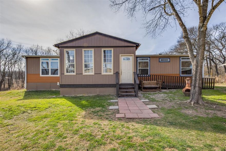 Great home! A Must See! Beautiful four-bedroom, two-bath home situated on approximately 2 acres and conveniently located in Weston with Celina ISD. The covered and enclosed front porch (17' x 12') offers a welcoming entrance and additional outdoor living space.  Inside, the home features decorative splatter-drag sheetrock finish, crown molding, and substantial baseboards throughout. Laminate flooring runs through the main living areas. The spacious family room includes a ceiling fan and recessed lighting.  The kitchen is designed for both function and style, featuring a 7' x 3' eat-in island, double sink, tile backsplash, stainless steel appliances (microwave and dishwasher), soft-close drawers, decorative cabinet hardware, recessed lighting, and a pantry. A nearby back door provides convenient exterior access.  A large mud or utility room offers space for a washer, dryer, and refrigerator, along with an exterior door leading to a 10' x 8' patio.  The generous dining room includes recessed lighting and offers flexibility for use as a second living area, game room, or home office.  The split-bedroom floor plan provides privacy for the primary suite, which features a ceiling fan, recessed lighting, crown molding, substantial baseboards, and a spacious walk-in closet. The en-suite bath includes a vanity with decorative hardware, built-in linen storage, and a large dual-head shower. Three additional bedrooms and a full bath are located on the opposite side of the home.  Outdoor amenities include an 11' x 10' covered grilling and smoking area, as well as a 21' x 10' fenced dog run with a 6' x 10' kennel and dog house. Plus a storm or tornado shelter!