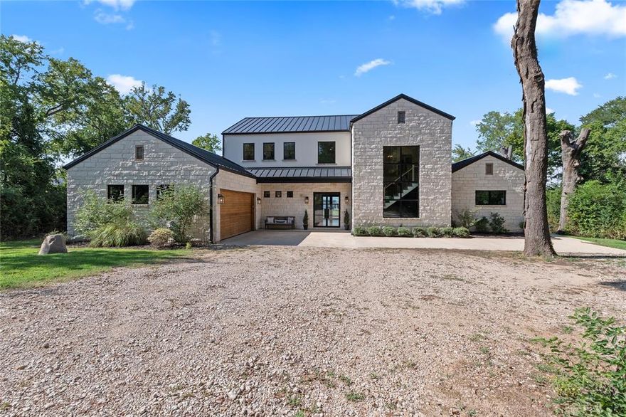 Nestled on 3.46 acres with 131 feet of open water front, this extraordinary estate is one of only 6 estate size homesites in the exclusive gated 505 Ranch just 45 minutes from Downtown Dallas. This premier community with 56 waterfront home sites lends lakefront luxury with ranch-style living across 505 pristine acres on the shores of Cedar Creek Lake. A long, wooded driveway leads to a striking modern lake home featuring open-concept great room flooded with natural light through tall windows that frame panoramic water views. A stone fireplace, built-ins, wood floors, and wood-beamed ceilings add warmth and character, while the state-of-the-art kitchen is a chef’s dream, featuring high-end appliances, a gas range, double ovens, and an expansive island with wine fridge and ice maker. The main level hosts two lake-view primary suites with baths along with a spacious utility room and a built-in workspace. Upstairs, the bonus room invites relaxation and entertainment with a large sectional, pool table, and wet bar equipped with a sink, fridge, and microwave. Two custom-designed bunk rooms, both with ensuite baths and water views, provide ample space for guests. Step outside to a large covered patio featuring a mounted TV, ceiling heaters, and a Coyote grill. Stunning pool with both heater and chiller, a stone firepit, and a lush lawn leads to private boathouse with composite decking, covered seating, two jet ski lifts, a boat lift and party deck. As part of 505 Ranch, residents enjoy exclusive access to over 400 acres of unmatched amenities including an equestrian center, guest cottages, polo field, pickleball courts, skeet range, hiking and ATV trails, stocked fishing ponds, a clubhouse, pool, sandy beach, and full-time ranch staff with concierge services. Whether you’re seeking a serene retreat or an active lifestyle, this rare offering delivers the best of both worlds.