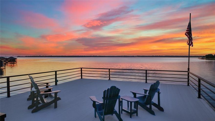 Nestled on 3.46 acres with 131 feet of open water front, this extraordinary estate is one of only 6 estate size homesites in the exclusive gated 505 Ranch just 45 minutes from Downtown Dallas. This premier community with 56 waterfront home sites lends lakefront luxury with ranch-style living across 505 pristine acres on the shores of Cedar Creek Lake. A long, wooded driveway leads to a striking modern lake home featuring open-concept great room flooded with natural light through tall windows that frame panoramic water views. A stone fireplace, built-ins, wood floors, and wood-beamed ceilings add warmth and character, while the state-of-the-art kitchen is a chef’s dream, featuring high-end appliances, a gas range, double ovens, and an expansive island with wine fridge and ice maker. The main level hosts two lake-view primary suites with baths along with a spacious utility room and a built-in workspace. Upstairs, the bonus room invites relaxation and entertainment with a large sectional, pool table, and wet bar equipped with a sink, fridge, and microwave. Two custom-designed bunk rooms, both with ensuite baths and water views, provide ample space for guests. Step outside to a large covered patio featuring a mounted TV, ceiling heaters, and a Coyote grill. Stunning pool with both heater and chiller, a stone firepit, and a lush lawn leads to private boathouse with composite decking, covered seating, two jet ski lifts, a boat lift and party deck. As part of 505 Ranch, residents enjoy exclusive access to over 400 acres of unmatched amenities including an equestrian center, guest cottages, polo field, pickleball courts, skeet range, hiking and ATV trails, stocked fishing ponds, a clubhouse, pool, sandy beach, and full-time ranch staff with concierge services. Whether you’re seeking a serene retreat or an active lifestyle, this rare offering delivers the best of both worlds.