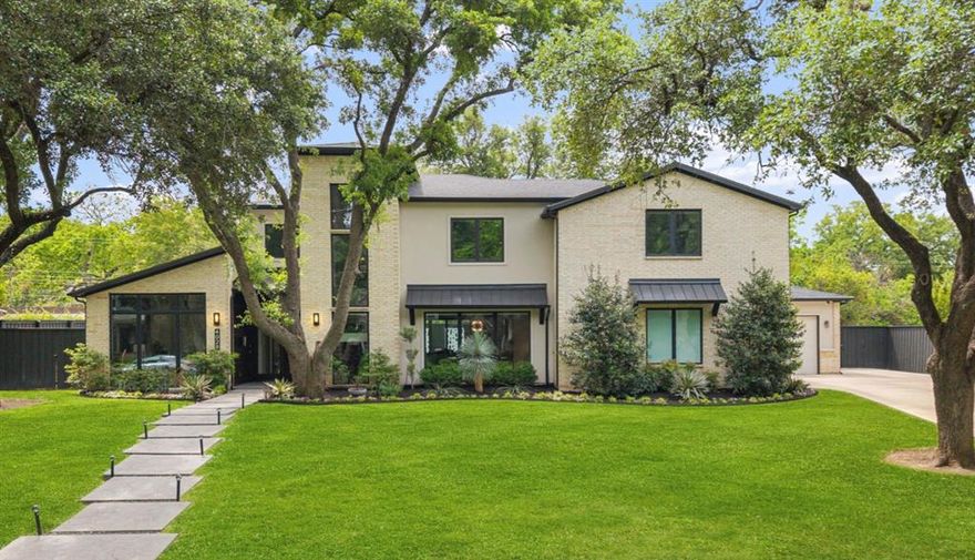 Timeless transitional offering 6,204 sq. ft. of refined, luxury living on a beautifully landscaped lot. Featuring 5 en suite bedrooms and 5.2 baths, this home is located in the heart of the Dallas Private School Corridor. Inside, hardwood floors span both levels, enhanced by designer lighting and expansive living spaces designed for both formal entertaining and relaxed living. The first-floor primary suite is a true retreat with a private sitting area overlooking the backyard. The spa bath includes dual vanities, dual water closets, a freestanding bathtub, a walk-in shower, a large custom closet, and direct access to the loggia. The gourmet chef’s kitchen is appointed with a Sub-Zero fridge-freezer, a Viking 6-burner gas range with an oversized oven, a Bosch dishwasher, a second oven, a warming drawer, and a walk-in pantry. A full second kitchen is located off the guest quarters. The main level further includes a front-facing study, large dining room, a family room with a gas fireplace and built-ins, and a secondary living room with a wet bar and beverage fridge overlooking the backyard. A fully integrated yet private downstairs guest suite features a secondary kitchen and direct garage access—ideal for extended family or guests. A desk area off kitchen, mudroom, and large utility room add further functionality. Upstairs, three additional en suite bedrooms with walk-in closets surround a spacious game room complete with a wet bar, beverage fridge, and half bath. Designed for year-round enjoyment, the covered outdoor loggia features a gas fireplace, phantom screens, and a large built-in BBQ overlooking a fully turfed backyard and putting green. Additional highlights include wiring for a Control4 smart home system and a 3-car garage with epoxy flooring. A rare offering with close proximity to shopping and the Northaven Trail, this move-in-ready property delivers elevated design and effortless indoor-outdoor living.