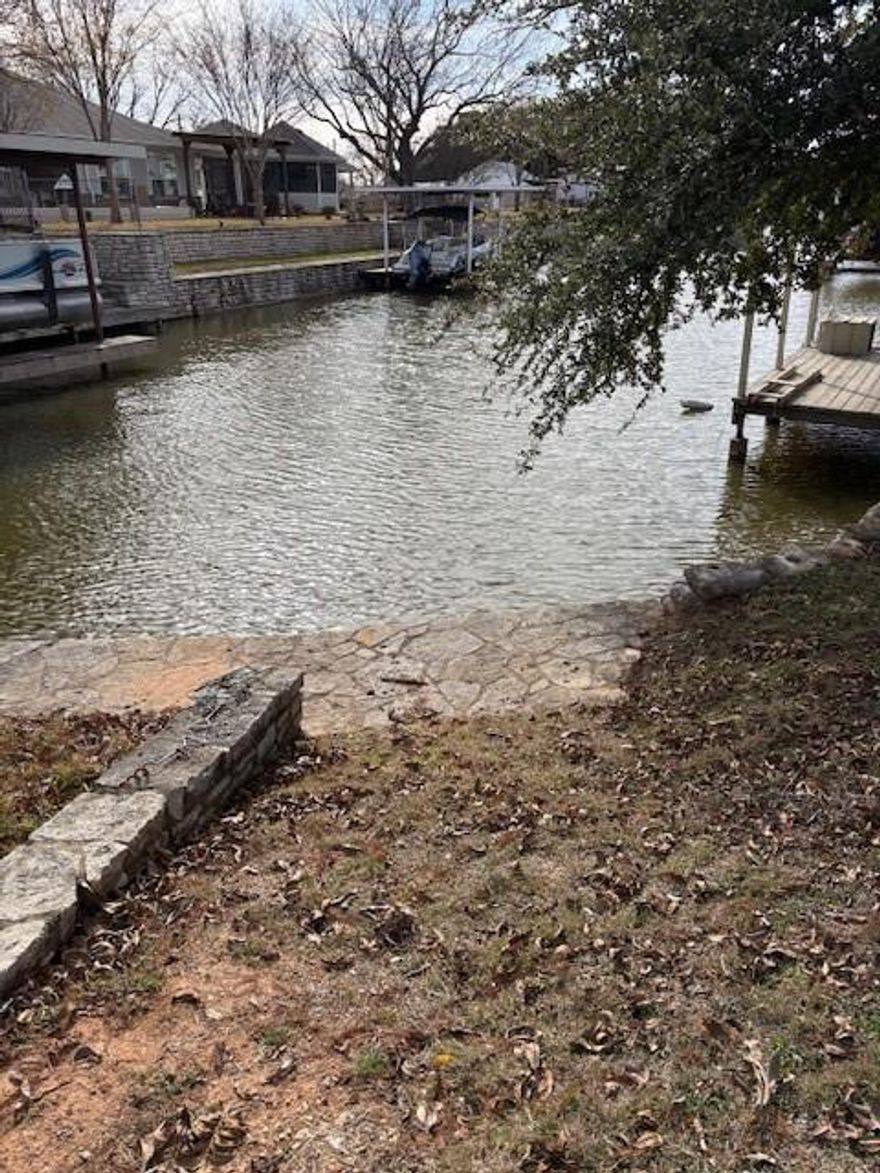 Don’t miss this lakefront Granbury gem! Featuring a 4-3-2 layout plus a private guest apartment, it’s ideal for a mother-in-law suite, extra living space, or rental income. Stylish updates include LED lighting, stainless steel appliances, custom tile backsplash, walk-in pantry, granite countertops, hardwood cabinets, dry stack rock accents, rain showerheads, bamboo and tile flooring, crown molding, and a utility closet with the main electrical panel. Added perks like an extended stained and stamped driveway, spray foam insulation, tankless water heater, zoned HVAC, water manifold system, and decked attic storage make it even better. Recent upgrades include a new septic system and a Class 4 roof installed in 2022. Just a short walk to the community clubhouse, boat ramp, and pool, this home perfectly blends lake living with home office convenience. Motivated seller—open to all offers.