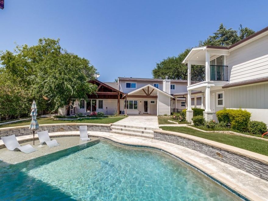 Escape to this resort style back yard, with beach entry pool, multiple covered seating areas, outdoor kitchen and pool house in the heart of the North Dallas private school corridor. Massive master suite on 1st floor along with multiple family rooms for entertaining. Upstairs there are 3 bedrooms, 2 with on suite baths. There is also a kids' sanctuary off one of the upstairs bedrooms. Gourmet Kitchen featuring Wolf and Viking appliances, large kitchen island with great views onto the outdoor living areas, sport court and pool. The back pool house includes a pool bath and shower along with a 3 car garage on first level, plus great living space upstairs above, featuring a complete media room, living and entertaining space, full bath with shower, plus an additional bonus room that would make a great kids and guest space for extended visits. Electric Gate secures the back yard parking pad and access to the garage.