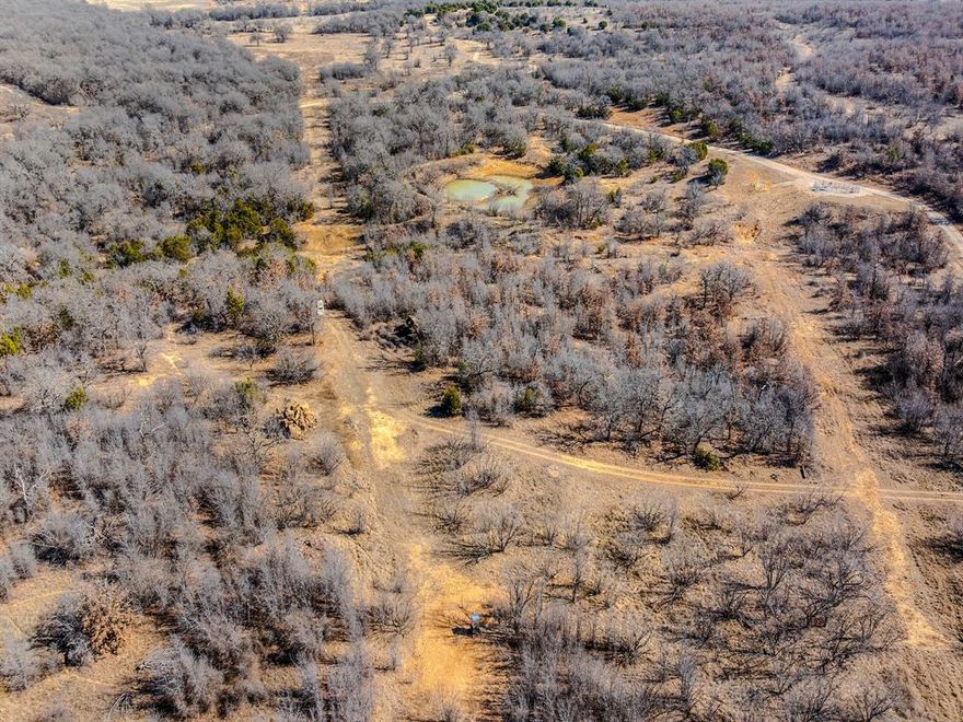 Spanning 206 acres in Jack County, near the Young County border, the Rhodes Ranch is a top-tier destination for hunters and ranchers alike. This expansive property is a haven for outdoor enthusiasts, offering well-maintained gravel roads throughout. It showcases varied topography, with more than 90 feet of elevation shifts, rolling hills, creek bottoms, and thick timber—ideal for supporting abundant game. The ranch offers superb hunting opportunities, with plentiful whitetail deer, turkey, dove, hogs, and varmints. Water resources are a standout feature, including four tanks (one always reliable) and Board Creek, which runs across the ranch, sustaining both wildlife and livestock. There are 47 acres of cleared land, perfect for food plots, crops, or improved grazing. Concrete crossings over Board Creek ensure easy travel across the ranch. Small working pens and a cattle shed support operational needs. For recreation, enjoy fishing, hiking, and panoramic views. Whether your goal is a hunting getaway or a working ranch, this property offers it all. And if desired, nearby ranches have water wells, suggesting the potential for one here, too.
