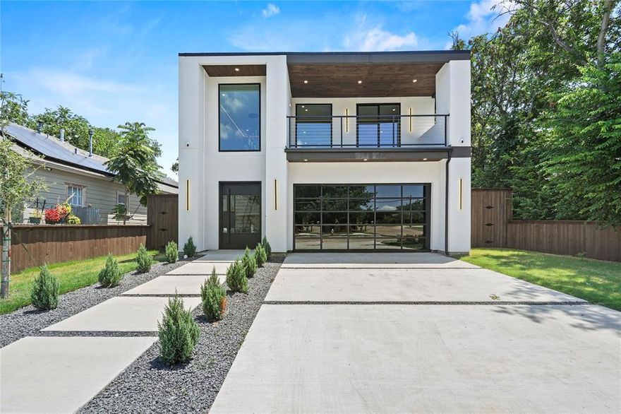 Get up to 2% using Preferred Lender towards buyer closing cost or upgrades. Welcome to this architecturally striking custom-built home offering 4,000 square feet of refined living in one of Dallas’ most dynamic and fast-growing neighborhoods. This 4-bedroom, 3.1-bath residence is a masterclass in design, quality, and comfort just minutes from Downtown Dallas, Trinity Groves, and major thoroughfares. From the dramatic arched hallway to the thoughtfully designed open-concept floor plan, every element of this home exudes sophistication. The chef’s kitchen is equipped with premium Cosmo appliances, Custom cabinetry, a Mounted Wine rack, and a wireless pop-up outlet perfect for both daily living and entertaining. Expansive living areas flow seamlessly into the outdoor spaces, where you’ll find a full outdoor kitchen and gas fireplace ideal for year-round enjoyment. The private theater room sets the stage for elevated movie nights, while ambient LED lighting throughout the home creates a warm and modern ambiance. Retreat to the luxurious primary suite featuring a spa-inspired bath with premium fixtures and high-end toilets throughout the home. Additional features include a Tesla charger, generator plug-in, and integrated smart home functionality. Curated with intention and built with precision, this home offers unmatched luxury, convenience, and style in West Dallas.