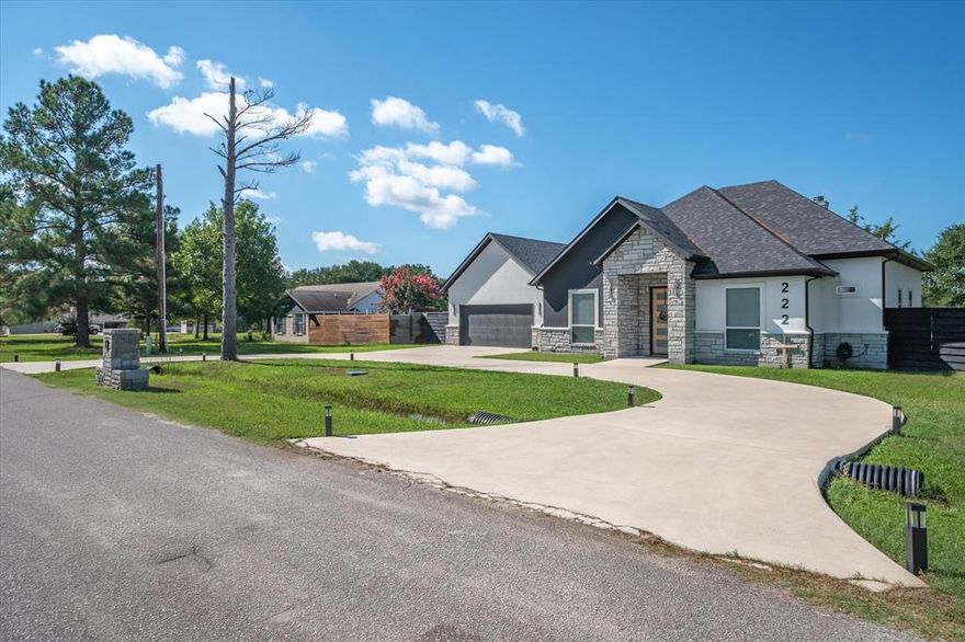 From the moment you arrive, this home in the gated Willow Lake Estates makes a lasting impression with its modern curb appeal and thoughtful design. The exterior features a striking combination of stone and sleek stucco with a welcoming front entry. A wide circular driveway offers both convenience and a grand approach for this magnificently modern home.  Step inside and you will be welcomed by soaring ceilings, modern lighting and a spacious living area which features a striking floor-to-ceiling fireplace and seamless flow into the kitchen and dining spaces—perfect for entertaining. The chef-inspired kitchen boasts a massive waterfall island with plenty of seating at the breakfast bar.  The homeowner purchased coordinating Cafe appliances for an upscale kitchen experience.  A dramatic black accent wall adds depth and modern flair to the ample dining area, making the space feel both sophisticated and inviting. The primary suite is large and the ensuite bath is something to be admired with its free standing tub and oversized glass enclosed shower.  Every detail is coordinated throughout this lovely home.  With a total of 4 bedrooms, one of which is a perfect office space if you choose, there is space for everyone.  The backyard is graced with a spacious covered patio with fans and extended deck.  A shed and backyard play system also convey with home!  All this PLUS you can enjoy the amenities of Willow Lake including a community park and dock.  Book your tour today!