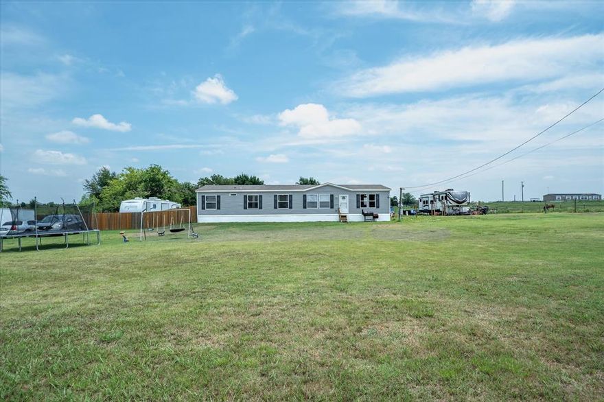 Country charm meets modern comfort, in the heart of Van Zandt County!  This 4-bedroom 2-bathroom 2020 mobile home nestled on 2 acres is awaiting your arrival. West facing home to capture the sunsets. Inviting entry to living room will greet your guests. Generous living spaces, and natural light.  Kitchen with center island provides an abundance of cabinetry and countertop food preparation space. Walk-in pantry, display shelving niches, and a dining table area to accommodate larger gatherings. Spacious primary retreat with full bath en suite, soaking tub, separate shower, dual sink vanity, and large walk-in closet. 3 additional nicely sized bedrooms share a full bathroom. Family or bonus room provides an additional living space. Home is equipped with AC. New aerobic septic system. Room to roam in a rural setting surrounded by nature, yet easy access to I-20 for commute to Dallas or Tyler. RV parking with 30-AMP & 50-AMP power. Parking galore! Ample space for livestock, gardens, recreation, with room to work + play. A blank canvas to intersect with your lifestyle. Close proximity to schools, shops, and the local vibe. This property is a rare opportunity to own a slice of Texas with room to grow, roam, work or relax. Primary residence or weekend getaway, this is it!