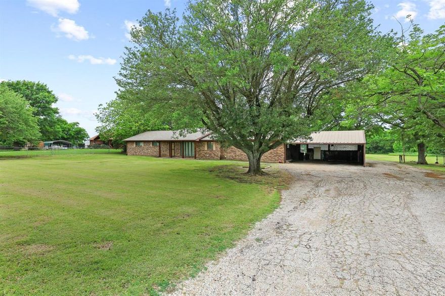 Welcome to 506 FM 816 Wolfe City TX 75496 sitting on 2.5 acres just outside Wolfe City.  This 3 bedroom, 2 bathroom home features an open living and kitchen design with an eat in kitchen, large island, and natural gathering space.

The large bonus room adds flexibility for a game room, workspace, or home gym and includes a wood burning stove.

The primary suite offers privacy with an ensuite bath. Outside, mature trees provide shade across the property, along with a covered back patio.. Additional features include a two-car carport and a storage shed with electric.

Serviced by Hickory Creek water and conveniently located on FM 816, this property offers country living with accessibility.