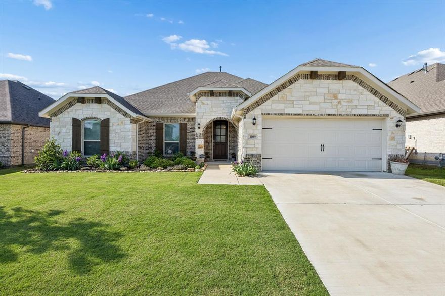 Move In Ready and can Close Quickly. A Beautiful White Austin Stone Front Elevation and Open Concept Design is ideal for Entertaining and Family Gatherings.  An Oversized living area that connects with your Dining and Kitchen provides multiples places for everyone, while still have Family Connectivity.  A SOUS CHEF Kitchen with a 36 inch GAS COOKTOP, Stainless Steel Appliances, California Island, Room for a 2nd Refrigerator and a WALK IN Pantry adds all the convenience to family dining or hosting friends.  Large windows throughout the home bring the outdoors in and Brightens up every room.  The extended living area in the backyard adds a designated spot for enjoying those Texas evenings under the stars and Summer Barbecues.  The Pool Sized backyard gives you a grassy canvas for many outdoor sports to be enjoyed by All.  Just 25 minutes North of Fort Worth, Amenities in the neighborhood include two pools with a splash pad, many parks, hiking-biking trails, a dog park, Pickleball, volleyball and picnic areas, and an on-site elementary school. Come and see this beautiful home today.