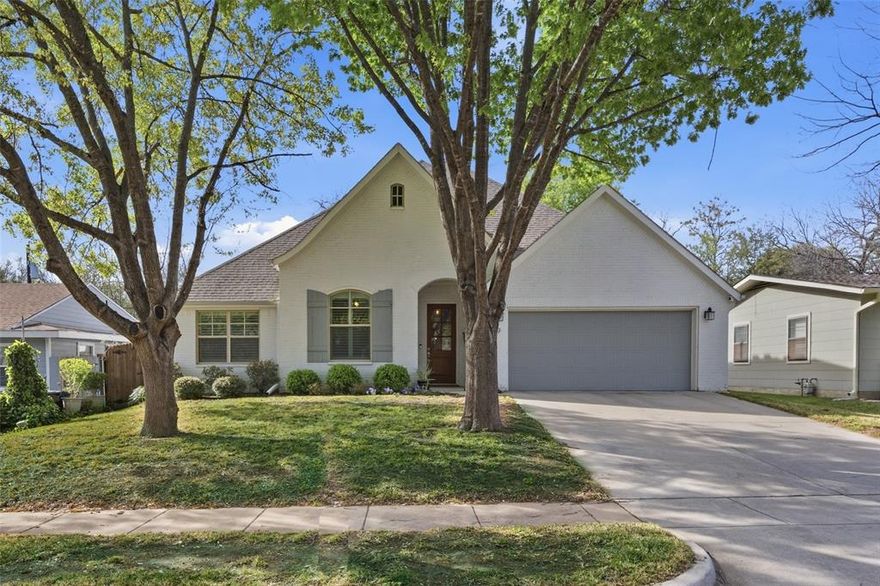 This beautifully designed 4-bedroom, 2-bath home, built in 2018, offers 2,317 square feet of thoughtfully stylish and functional living. The painted Tudor-style exterior creates charming curb appeal in a prime Fort Worth location. Inside, rich hardwood floors flow throughout the foyer, study, living room, dining room, kitchen, breakfast nook, pantry, and hallways creating warmth and continuity throughout the home. The kitchen is designed for both everyday living and entertaining, featuring granite countertops, custom wood cabinetry, a wood vent hood, stainless steel appliances including a gas range, and a large island. The inviting living area centers around a wood-burning fireplace with gas starter, while plantation shutters on all windows add timeless style and privacy. The flexible fourth bedroom easily functions as a private office or study, ideal for today’s work-from-home lifestyle. Smart home features have been added including a whole-house surge protector. With its combination of classic character, quality craftsmanship, and functional floor plan, 5849 Dennis Avenue offers the perfect blend of charm and modern living.