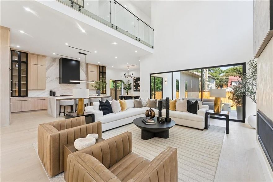Nestled in the coveted C Streets of Lakewood Heights — zoned to Lakewood Elementary and minutes from White Rock Lake, premier dining, and the best of Dallas — this fully custom new construction is a rare opportunity to own a home built without compromise.
From the moment you enter, the architecture commands attention: 22-foot ceilings, walls of glass, a floating staircase with motion-activated LED lighting, and a dramatic fireplace that anchors the main living space. Venetian plaster walls, designer lighting, and handselected stonework layer warmth and texture throughout — grounding the clean modern aesthetic in something that genuinely feels like home.
The kitchen is equal parts showpiece and workhorse, centered on an oversized real stone waterfall island with Thermador appliances, custom rift-cut oak cabinetry, and a fully concealed prep kitchen with additional Bosch appliances — so entertaining at scale never shows.
The downstairs primary suite is a true retreat, defined by spa-inspired finishes and striking marble slab installations that read more as art than architecture. A separate guest suite on the main level adds flexibility for visitors or multigenerational living.
Upstairs, generous bedroom suites open to an exceptional collection of bonus spaces — a dedicated media room, game room, and wellness studio — giving every member of the household a space that feels like their own.
Sliding glass doors connect the main living area to a dramatic stepped-down backyard with expansive green space, genuine privacy, and the ideal footprint for the resort-style pool the neighborhood calls for.
In one of Dallas' most sought-after pockets, at one of the finest schools in the city — this is the home Lakewood buyers have been waiting for.