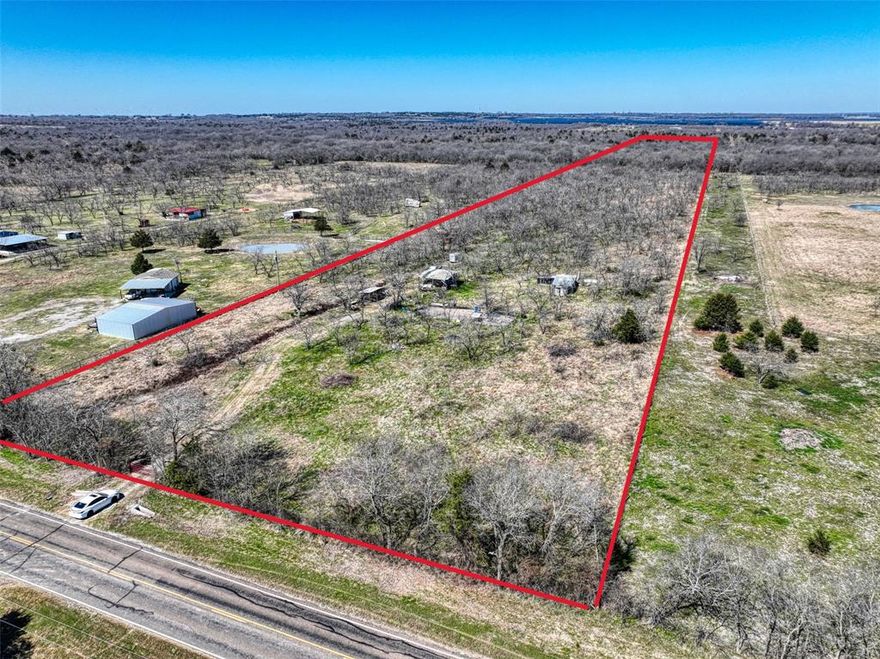 10.04 acres in Navarro County with FM 641 frontage in Wortham ISD—ideal for a weekend getaway or future homesite. Property includes a 20’ concrete culvert for access plus existing RV setup with (1) 30-amp hookup on a standard pedestal, Oncor electric meter in place, and co-op water with meter present. Heavily treed with mesquite throughout and mature trees toward the back for added privacy. No fence, no septic installed (no sewer), and seller reports no floodplain. Land only—buyer to verify utilities, restrictions, and intended use.