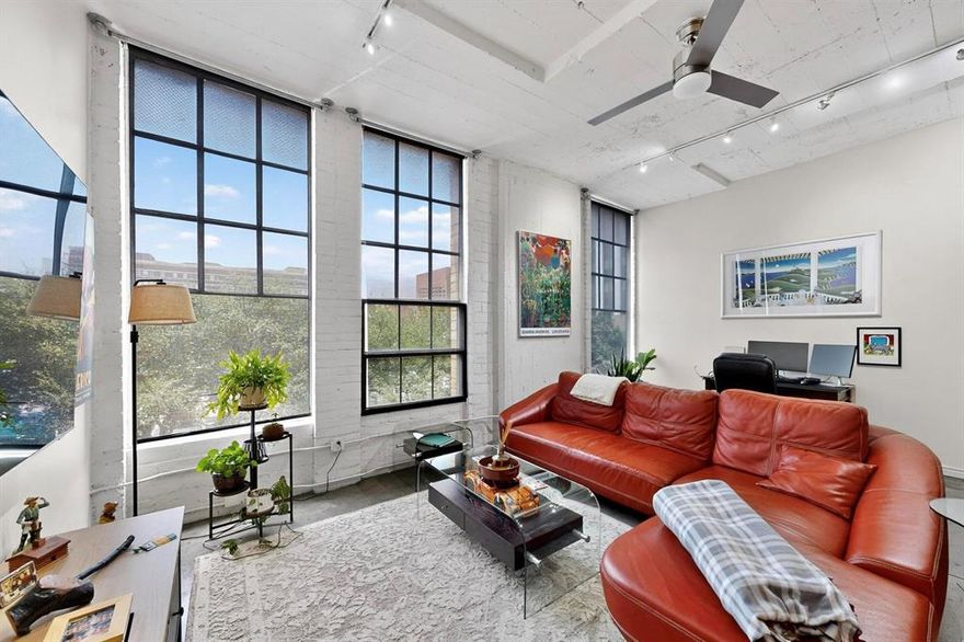 Enjoy the lock-and-leave lifestyle at the SoCo Urban Lofts. ALL APPLIANCES CONVEY! Historic Dallas meets modern living in this spacious condo with a versatile open floor plan perfect for creating your dream layout. Flooded with natural light, featuring authentic industrial details like vaulted ceilings, exposed concrete & expansive wall space ideal for art & decor, with track lighting designed to showcase your stylings. A large kitchen island anchors the main space with additional built-in storage beneath the island. Kitchen is complete with ample cabinet storage, stainless steel appliances & granite countertops. Sitting along a wall of windows equipped with premium shades, this generously sized living room easily accommodates a dedicated work-from-home space. Separate bedroom offers added privacy, with a custom wall of storage & closet space to maximize functionality. Laundry is conveniently tucked between the hallway & bathroom, with more built-in storage. Building amenities include a rooftop retreat with Dallas skyline views, a sparkling pool & outdoor grills, a fully equipped fitness center with yoga & boxing rooms, PLUS private storage on the same floor as the unit. HOA covers high speed internet, water, trash & sewer, with a 24-hour concierge available. Enjoy urban living at its finest in this historic building in the heart of Downtown Dallas, originally built in 1925 as part of the Santa Fe Terminal Complex and later home to WFAA offices. This iconic structure has been transformed into one of the city’s most stylish condo residences, close to every amenity you could possibly need. Near shopping, dining, entertainment & nightlife with easy access to major highways. Steps to the Dallas Arts District, Klyde Warren Park, Dallas Farmers Market, the AT&T Discovery District, Uptown + much more!