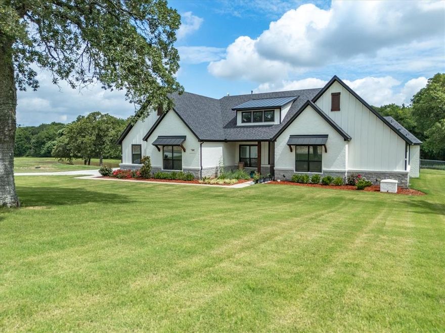 Welcome to your dream home in the highly sought-after neighborhood of Las Brisas in Decatur Texas.  This stunning 4-bedroom, 4-bathroom modern residence, is situated on a picturesque 4.5-acre lot featuring a serene pond and beautiful trees. Boasting 3,069 sq. ft. of elegant living space, this home offers an open floor plan designed for contemporary living and entertaining. The heart of the home is the gourmet kitchen, equipped with a large island, gas stove, farmhouse sink, and an extra ice maker. The kitchen seamlessly flows into the large, cozy living area, highlighted by exposed wood beams and a striking stone fireplace. The primary suite is a private retreat with an en suite bathroom featuring a soaking tub, dual sinks, separate vanities, & a large shower. Additional features include a water filtration system, water softener, and a gas hot water heater. Enjoy the tranquility of country living with all the modern amenities in this gorgeous home! Call today to schedule a showing!