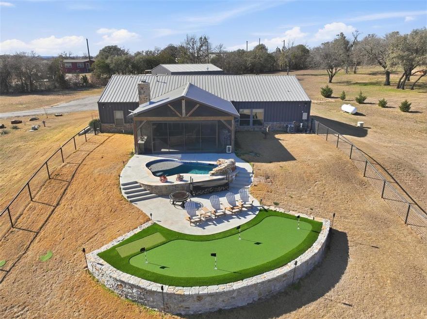 Stunning barndominium situated on 4.2 acres just north of Granbury. This impressive 2,224 square feet home offers the perfect blend of comfort, space, and versatility. Featuring four bedrooms and two and one half baths, the home is thoughtfully designed with dual master closets complete with built-in chests. Open floor plan with a large open kitchen, huge island and large walk-in pantry. A spacious living room offers a great view of the back patio with twelve foot Bi Fold Aluminum doors that can create even more open space. Stay cozy with two pellet stoves in the living room and primary bedroom each. Enjoy year-round outdoor living on the large screened back patio with a wood-burning fireplace, overlooking a heated pool ideal for relaxing or entertaining. The property also includes a 30 x 50 insulated, climate-controlled shop with a private efficiency apartment, making it perfect for guests, hobbies, or additional income. A rare opportunity with room to live, work, and play.