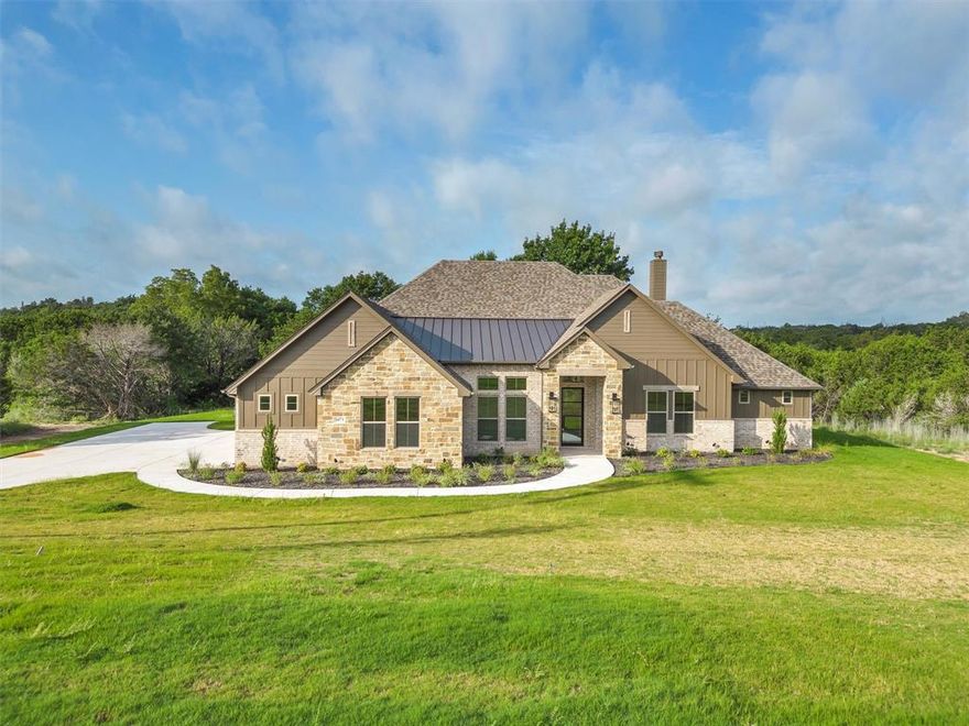 Welcome to Luxury, Nemo (Glen Rose) Texas style! This beautiful home on 1-acre combines timeless appeal with modern touches. Its large windows and natural stone elements enhance its curb appeal, while the interior is complete with a spacious study off the entrance, a living room with a fireplace and ceilings that are highlighted by beautiful wood beams. Finally a kitchen with plenty of beautiful granite counter space thanks to the butler's pantry. The luxurious primary suite features vaulted ceilings, a spa-like bathroom, and two walk-in closets. Additional bedrooms offer walk-in closets and a shared jack and jill setup. The practical mudroom connects to a three-car garage, keeping the home organized. Ideal for both relaxation and entertaining, this home effortlessly blends sophistication with comfort. The Vista Ridge neighborhood is ready to welcome you with your brand new SWP Custom Home!
