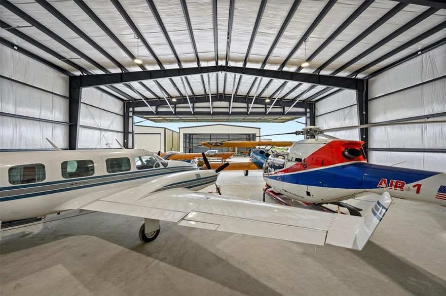 Need a private showroom for your car collection? Or, are you looking for hangar space for your new aircraft? Need space for your motorcoach, boats and toys? Come build your 'bragging rights' showroom at 9400 Beagle Lane at Aero Country East Airport (T31), a secure, gated aviation community in McKinney, Texas. This hangar lot is one of the LAST HANGAR LOTS WITH  *BRING YOUR OWN BUILDER RIGHTS*  FOR SALE AT  T31 AERO COUNTRY AIRPORT EAST.  ***OWN THE LAND. NOT A GROUND LEASE!*** HAVE US BUILD YOUR SHOWROOM HANGAR OR BRING YOUR OWN BUILDER. Add a man-cave; apartment residence; office and conference room*, the sky is the limit!  Hangar not included in lot sales price. BUILD REQUIREMENTS: 60 X 60 X 25 HANGAR. Ask for full build requirements. New hangar & residential development at Aero Country East.  T31 a privately owned, public use airport located between Frisco, McKinney & Prosper, in the North Dallas Texas Metroplex. Gated, luxury hangar & residential airport ~ airpark, with community pool and amenities for the exlusive use of Owners & guests.

• Paved & lighted, 3,100' runway & 1,500' airstrip, continuous.

• Dedicated taxiways. 

• Build your 60' x 60' Hangar, with 54' Hangar Door.

• CORNER HANGAR LOT: Add rollup door for your Big Toys, RV's & Trailers. 

• Bring your planes, cars & toys, and join the Airpark Lifestyle! 

• Pilots Quarters, Residences & (non-public facing) office - conference rooms, Allowed

• (No Homesteading tax break for aircraft hangars.)

• RETAIL OR PUBLIC-FACING COMMERCIAL BUSINESS USE, STRICTLY PROHIBITED.

• NO FLIGHT SCHOOLS.

• Roadways, taxiways, runways & airstrip, completed.

• Underground Utilities, installed.

• City Water & City Sewer, CoServ Natural Gas & Electric Co-Op, AT&T Fiber Optic Internet, Cable & Phone.

Come be a part of an amzaing aviation community of Aero Country East. Schedule your tour. Please note this is a Gated Airport Community. No unauthorized vehicles. Showing appointment required.