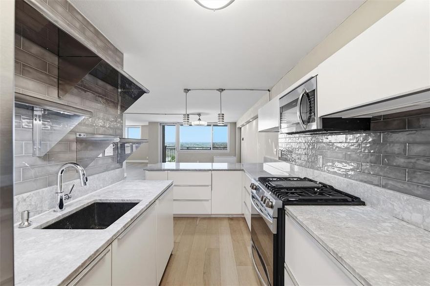 Turn key living in this updated 16th floor corner unit condo overlooking Highland Park and all of North Dallas. From the bedroom watch planes land at Love Field. This unit has a drop in gas range, granite counter tops and bar, tile backsplash, farmer's sink, custom fans and lighting, wood floors through out, large balcony, 2 updated baths. Dues include full use of community pool, hot tub, grill, park area, HVAC, electric, gas, 2 covered parking, lobby sitting area, library, and work out room.