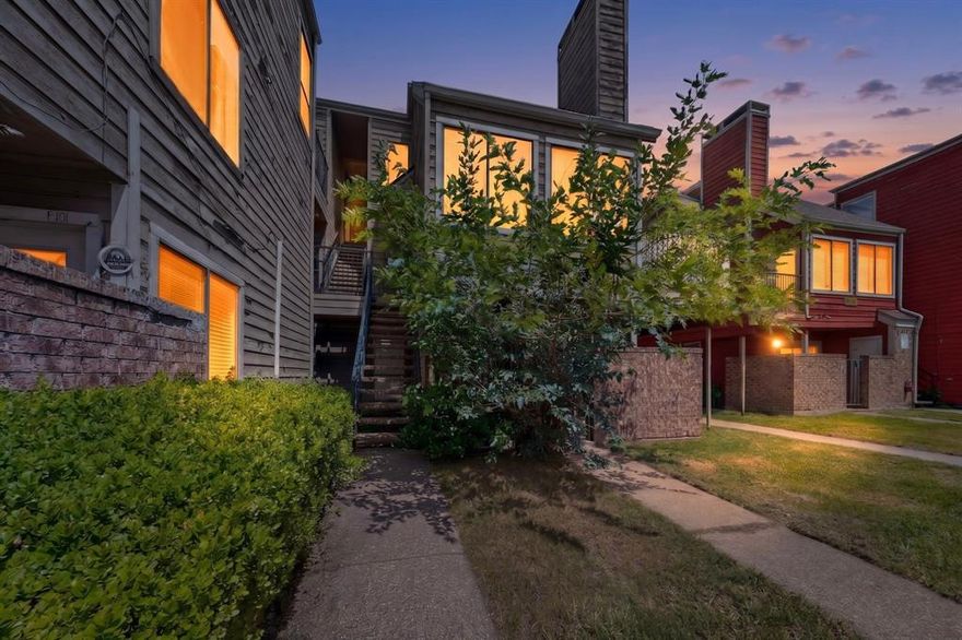 Two-level condo with 2 bedrooms, 2 full baths, and 894 square feet at 9811 Walnut Street #F203. The main level features an open living area with vaulted ceilings, wood-style flooring, and a stone-accent fireplace that gives the room a strong focal point. The kitchen offers white cabinetry, gray countertops, stainless appliances, and a breakfast bar that opens to the living area. A downstairs bedroom, full bath, and in-unit stackable laundry keep the main level practical and easy to live in, while the upstairs loft-style second bedroom includes its own closet and full bath for added privacy and flexibility. Recent improvements include a 2023 HVAC replacement, 2025 water heater installation, 2025 garbage disposal installation, and 2026 cooling system tune-up. Service records available. Convenient Dallas location near shopping, dining, and major access points.