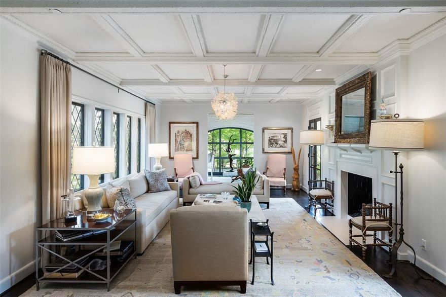 Magical gated estate on 1.7 treed and landscaped acres, with beautiful Tudor designed by Charles Dilbeck and transformed, expanded and updated by David Stocker and SHM architects. Retaining all the beautiful charm and whimsy that Dilbeck homes are known for, this one-of-a-kind home offers multiple living areas, gorgeous formal dining room, kitchen and catering kitchen open to casual living, downstairs primary suite with reading nook and fireplace, sumptuous bath with heated floors & walk in closet, and natural light throughout. Upstairs includes four unique bedroom suites and casual  living with vaulted ceiling and original stained-glass windows. Technology and features galore with Lutron lighting, electronic shades, surround sound wiring and enhanced security. The outdoor spaces are amazing, with pool, yard, gardens, including a walled garden, chicken coops, storage, and more! 3 car detached garage. Drive in through wrought iron gates into your enchanting Preston Hollow retreat.