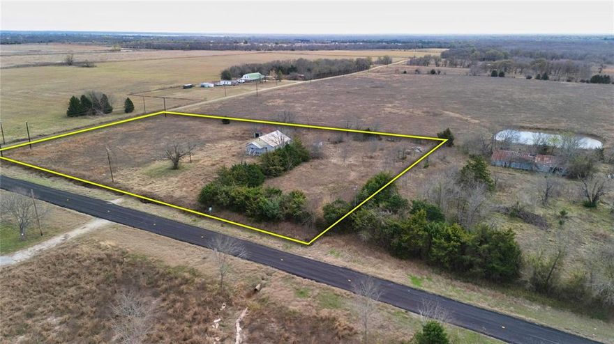 Opportunity meets flexibility on this 2.73-acre tract with direct frontage along FM 1528 in Delta County. Located just 10 minutes from Cooper and 15 minutes from Commerce, this property places you within reach of essential amenities while offering space and freedom to create your own vision. It includes an existing home on site, but the property is being marketed and sold for land value. The home may be suitable for renovation, rebuild, or removal giving buyers full control over use and investment strategy. Flat terrain, scattered trees, and access to water and electric make this a practical and build-ready option for anyone seeking land with infrastructure already in place. A recently installed water line runs along the frontage, and a meter is available. With no zoning or deed restrictions, the options are wide open for residential, agricultural, or mixed-use development.
The land offers privacy with quick access to larger destinations like Greenville (30 minutes) and McKinney (about an hour). Outdoor enthusiasts will appreciate the proximity to Jim Chapman Lake and Cooper Lake State Park, both just minutes away, offering boating, fishing, trails, and equestrian access. Majority of aerial photos show the entire multi-tract parcel. Outlines shown are approximate and for visual reference only.